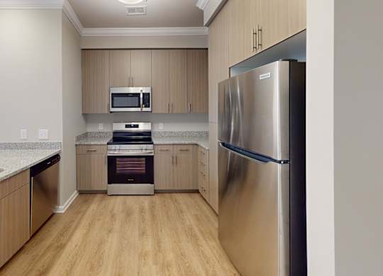 a designer kitchen with granite countertops and stainless steel appliances
