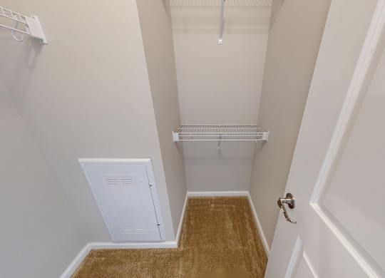 a walk-in closet with built in shelving