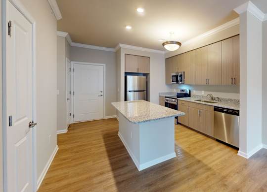 a kitchen with an island and granite countertops