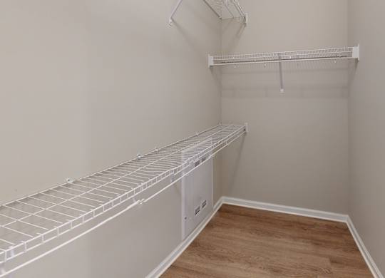 a large walk-in closet with shelving