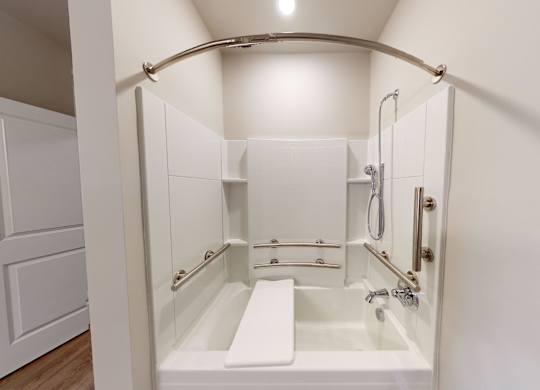 a garden tub with handrails