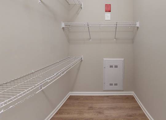 a large walk in closet with shelving