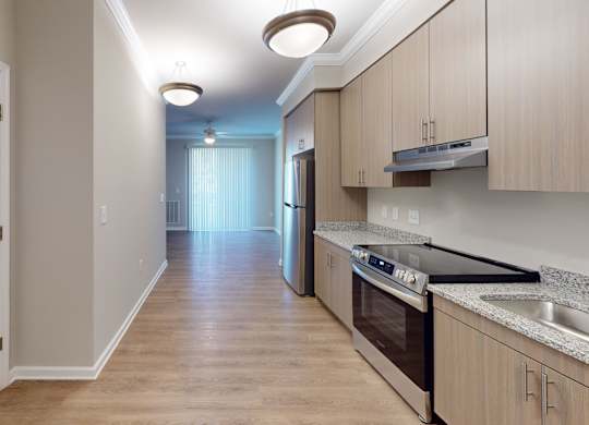 a kitchen with granite countertops and stainless steel appliances