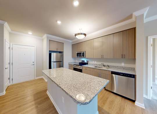 a kitchen with an island and granite countertops