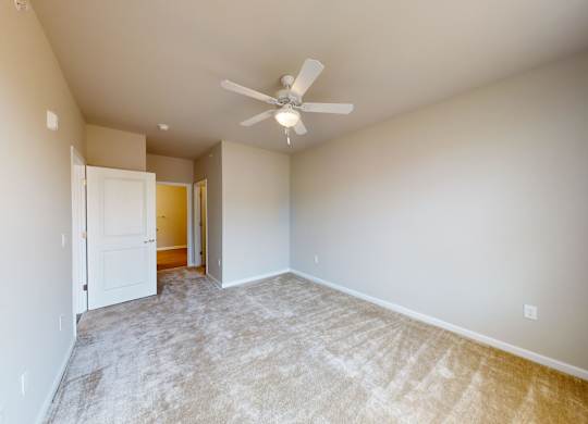 a bedroom with a connecting closet and bathroom