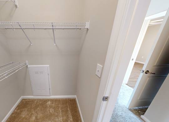 a walk-in closet with shelving