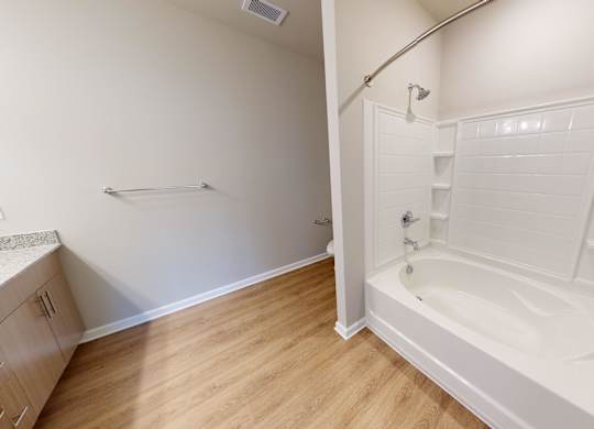a bathroom with a tub and vinyl flooring