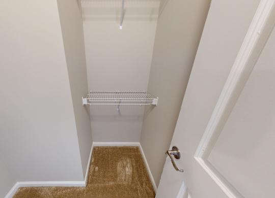 a walk-in closet with shelving