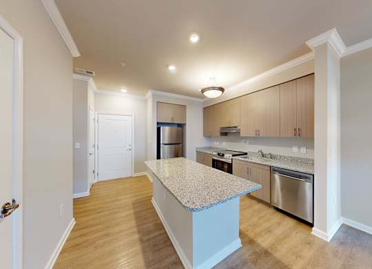 a kitchen with an island and granite countertops