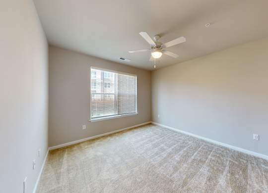a bedroom with carpet and a ceiling fan