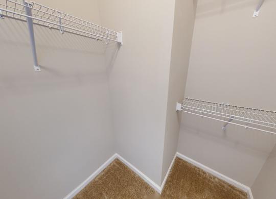 a walk-in closet with shelving