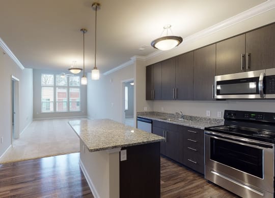 Kitchen with island open to the main living area with sunroom