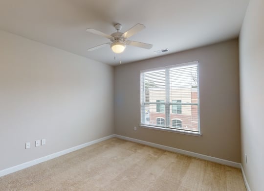 Bedroom with ceiling fan, carpet and window