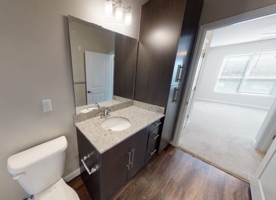 Bathroom with sink, toilet and storage cabinet