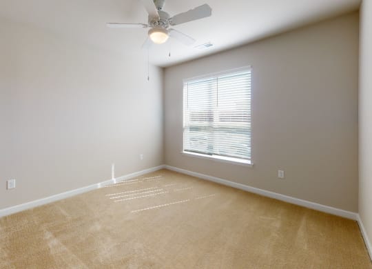 Bedroom with ceiling fan, carpet and window