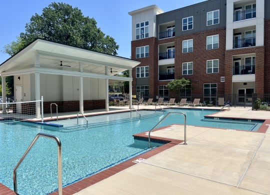 a swimming pool with a building in the background