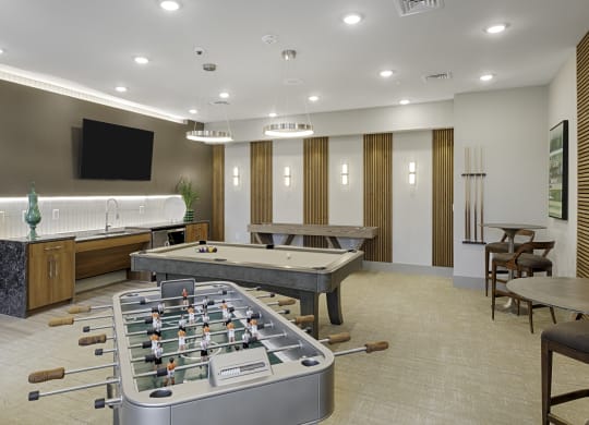 Game room with foosball table, billiards, shuffleboard, flat screen TV
