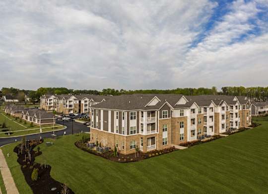 A large apartment complex with multiple buildings and green lawns.