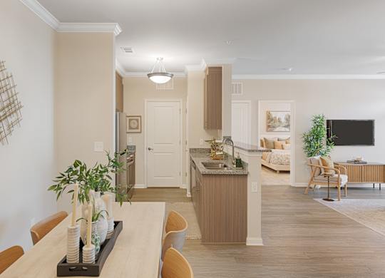 A kitchen with a dining table and chairs in the foreground.