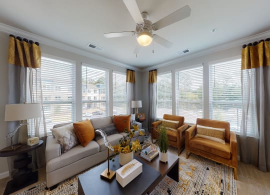 Living room with windows, ceiling fan, carpet