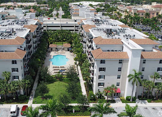 A large apartment complex with a pool in the middle.