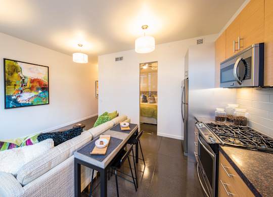 A kitchen with a stove top oven and a microwave above it.