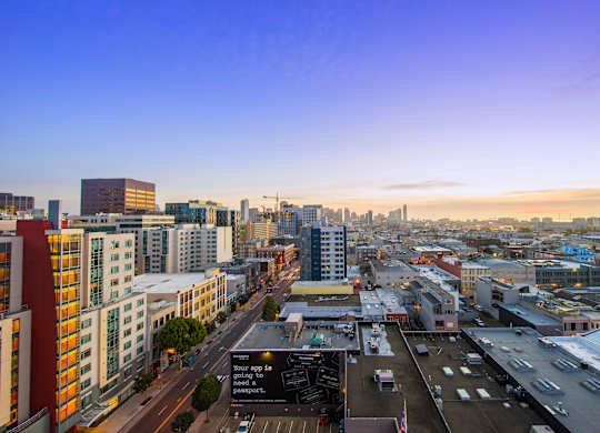A cityscape with buildings and a clear sky.
