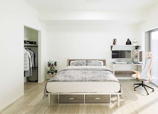 A bedroom with a bed, desk, and chair.