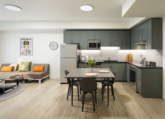 A modern kitchen with a dining table set for two.