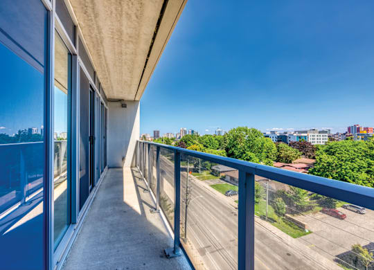 A balcony with a view of a highway and buildings.
