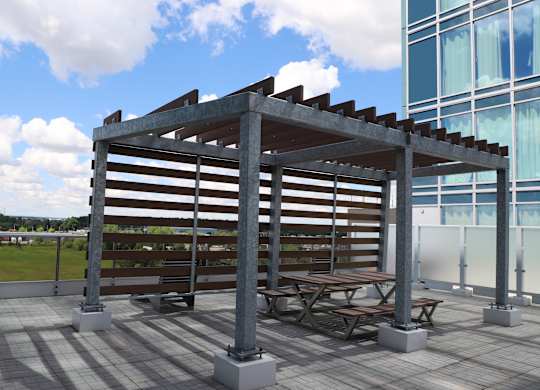 a group of picnic tables under awning on a patio next to a building