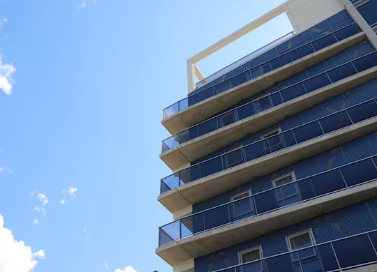 the side of an apartment building with blue sky