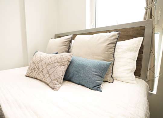 a bedroom with a bed with pillows on it