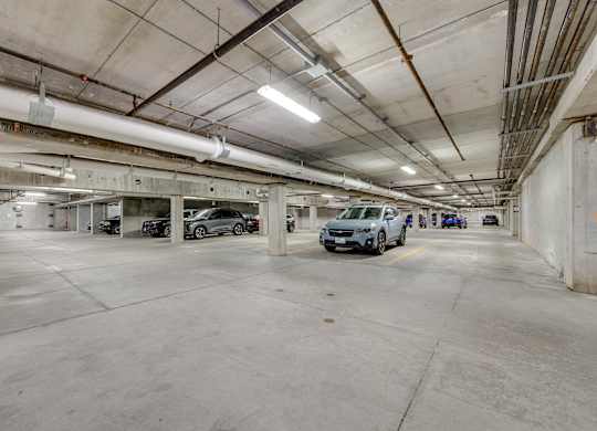 A parking garage with several cars parked inside.