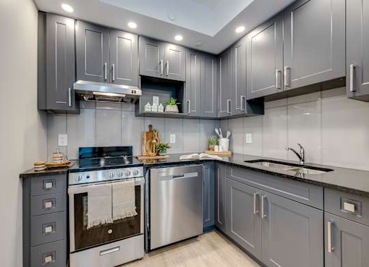 A modern kitchen with a stainless steel oven and sink.