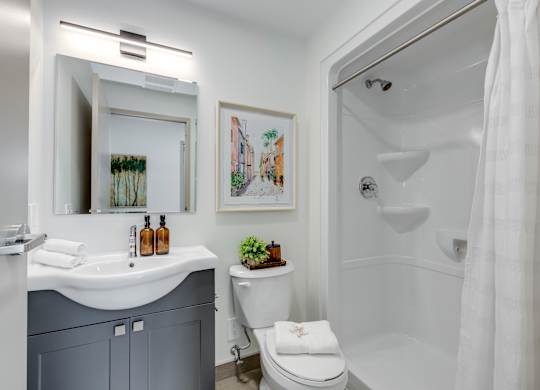 A bathroom with a white toilet and a white sink.
