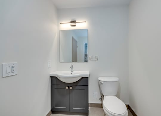 A white toilet sits next to a sink in a small bathroom.