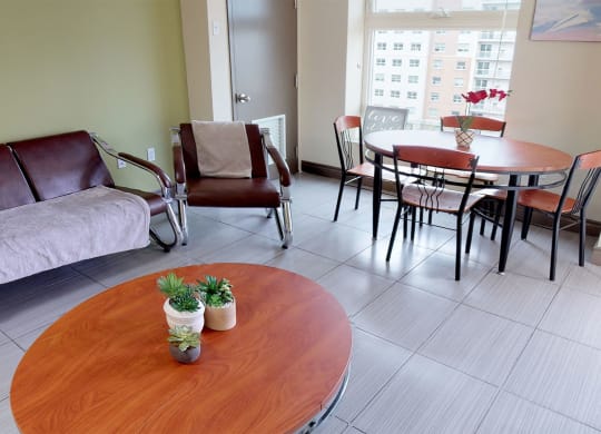 a living room with a table and a couch and a dining room