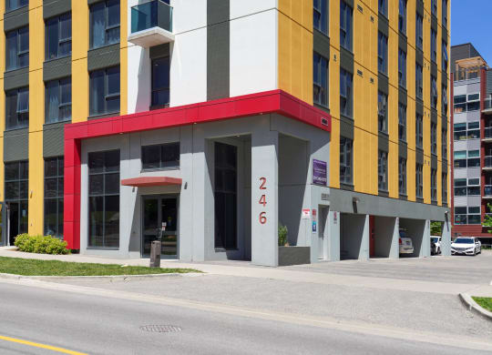 a building with a red and yellow facade on a city street