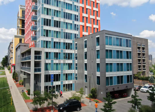 an aerial view of two modern buildings on a city street