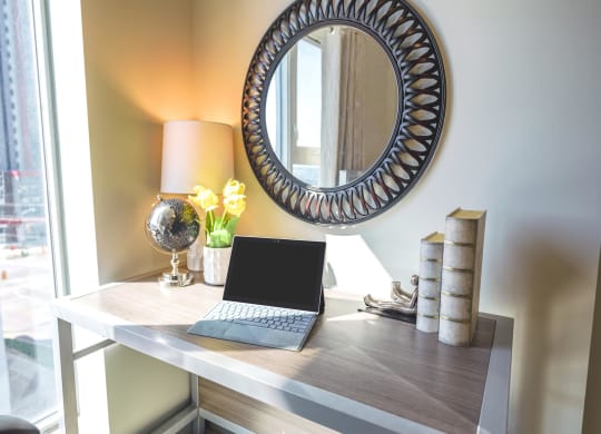 a laptop computer sitting on a desk in a home office