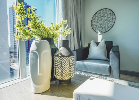 a living room with a couch and a vase with flowers