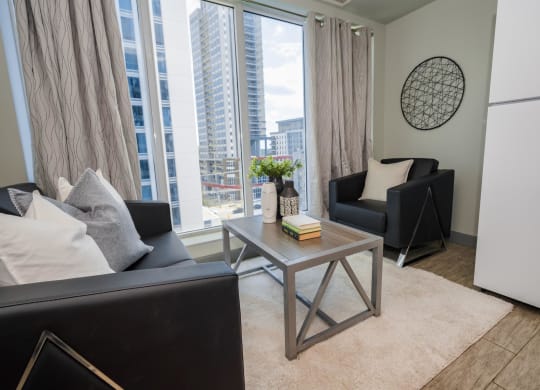 a living room with a large window and a couch and a table