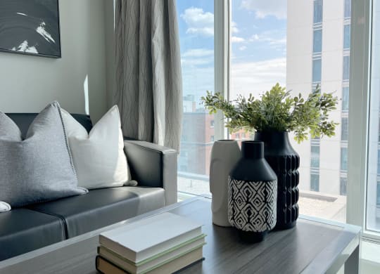 a living room with a couch and a table with a vase