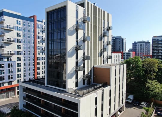 an aerial view of a building in a city with tall buildings