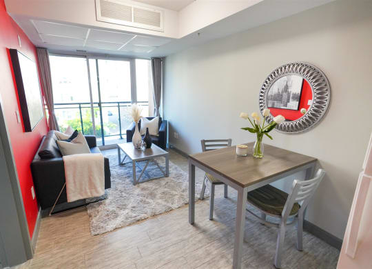 a living room with a table and chairs and a mirror