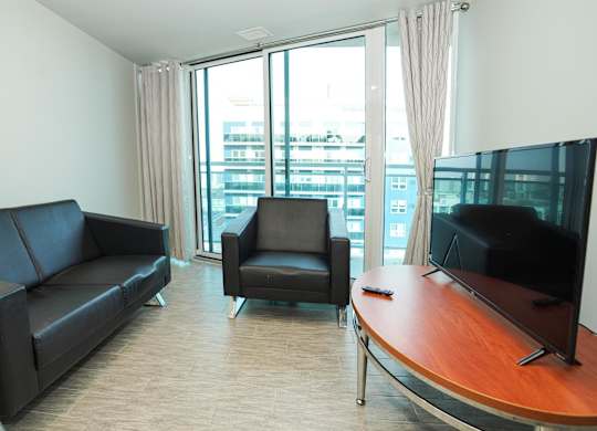a living room with a couch and a table and a tv
