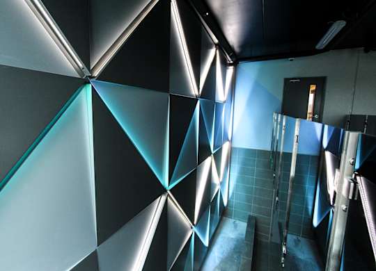a blue and black wall in a room with a ladder