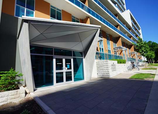 a building with a glass door and awning in front of it