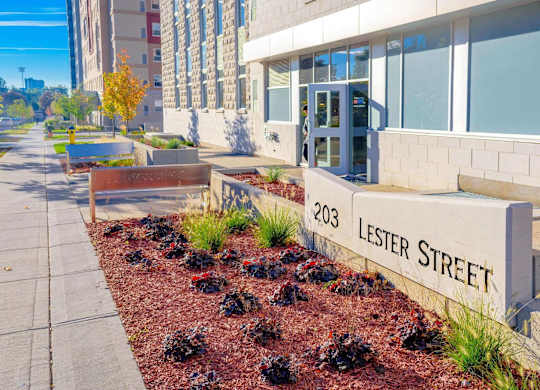 A street sign for Lester Street is in front of a building.